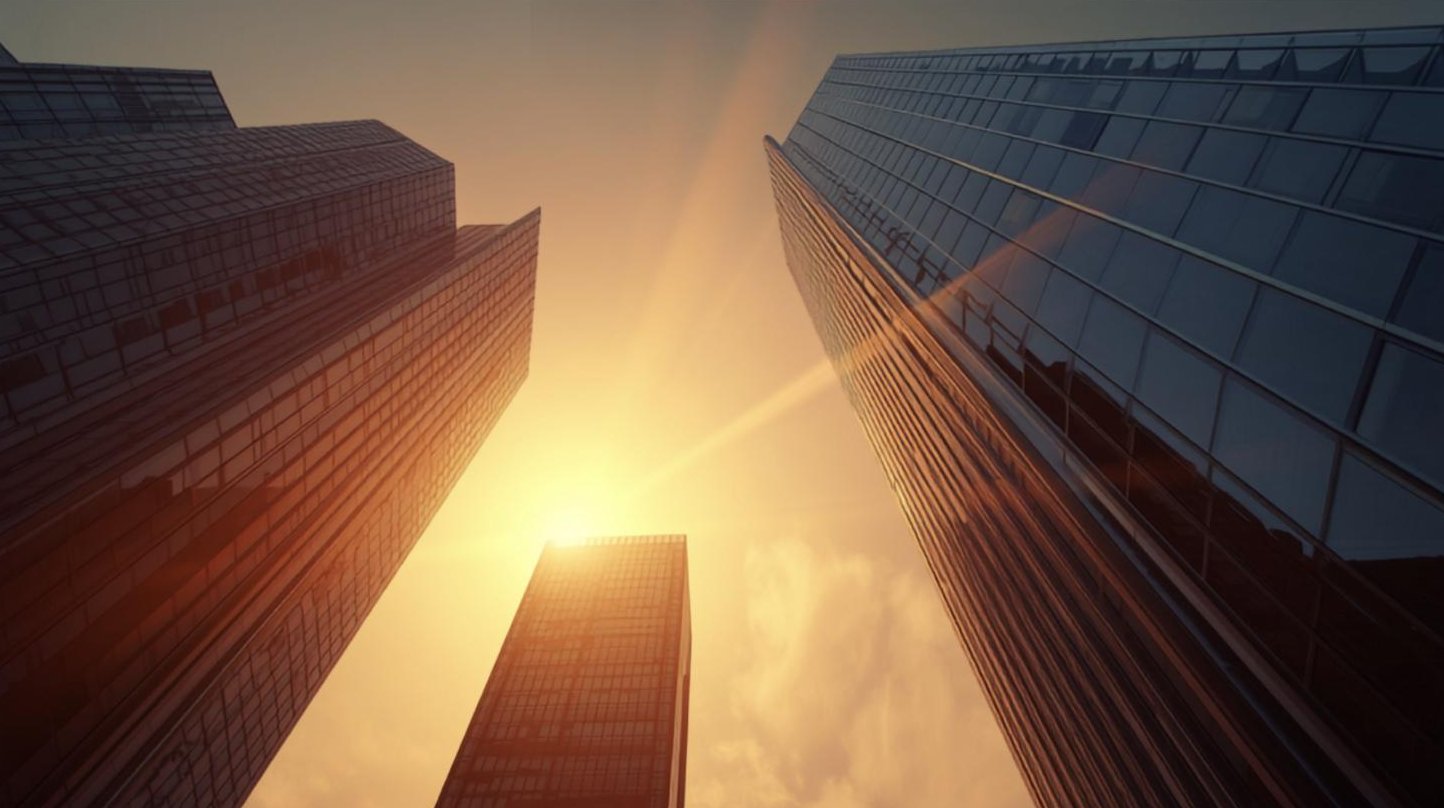 Glass office towers in golden-hour light